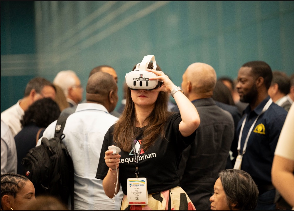 An Aequilibrium team member trying the VR4Health headset at a health-care conference